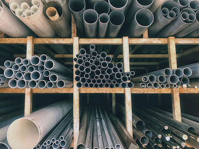 Steel and PVC pipes in a plumbing supply warehouse
