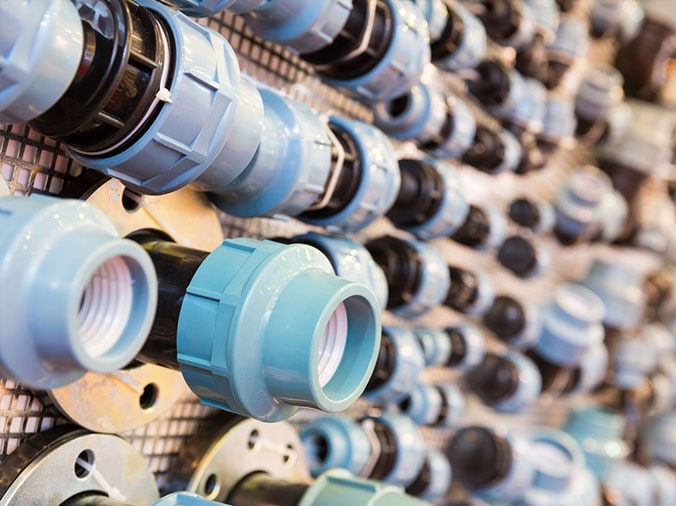 PVC unions on a wall in a plumbing store